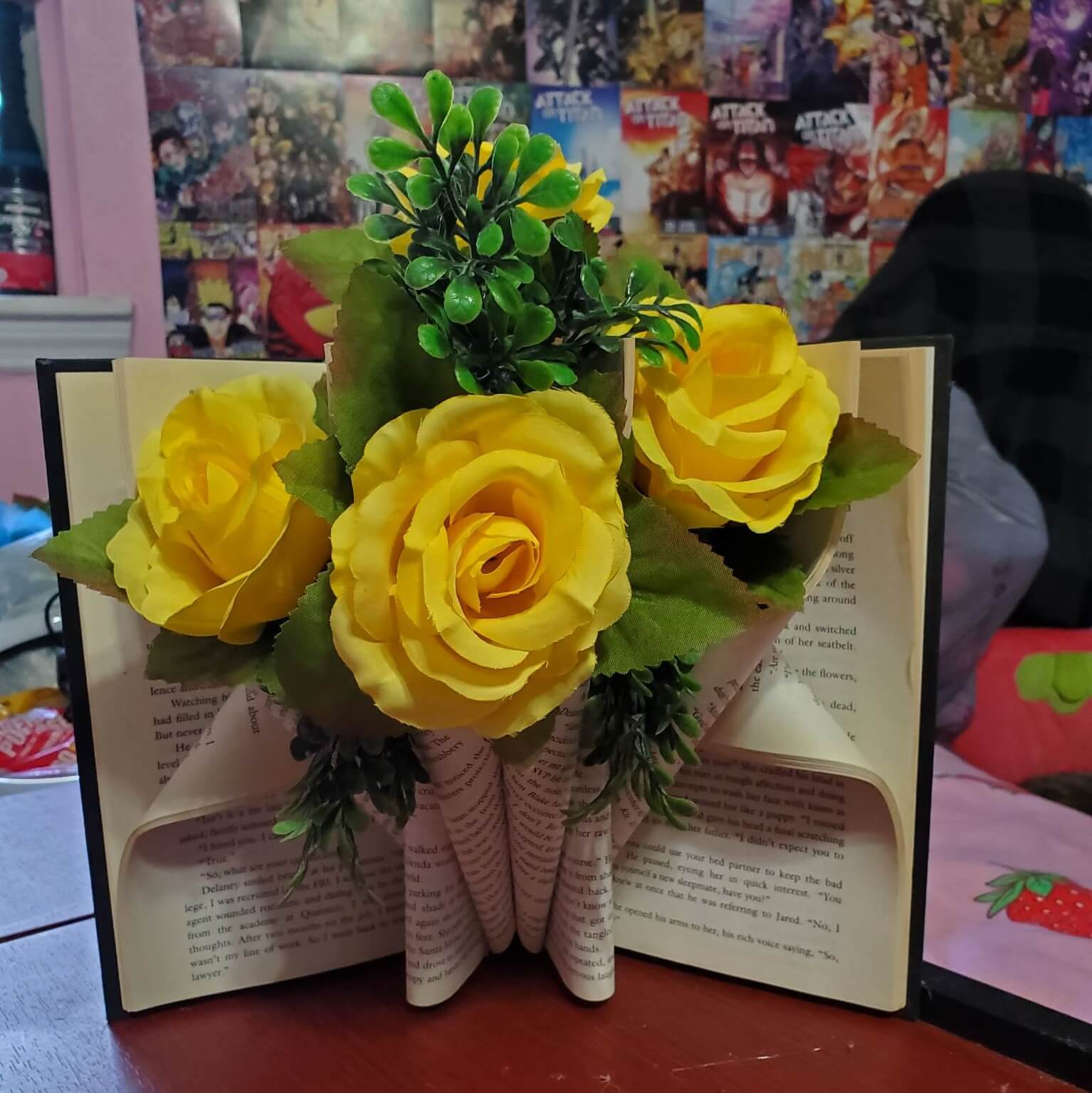 Crystalised folded book with yellow roses appearing to grow from the top.